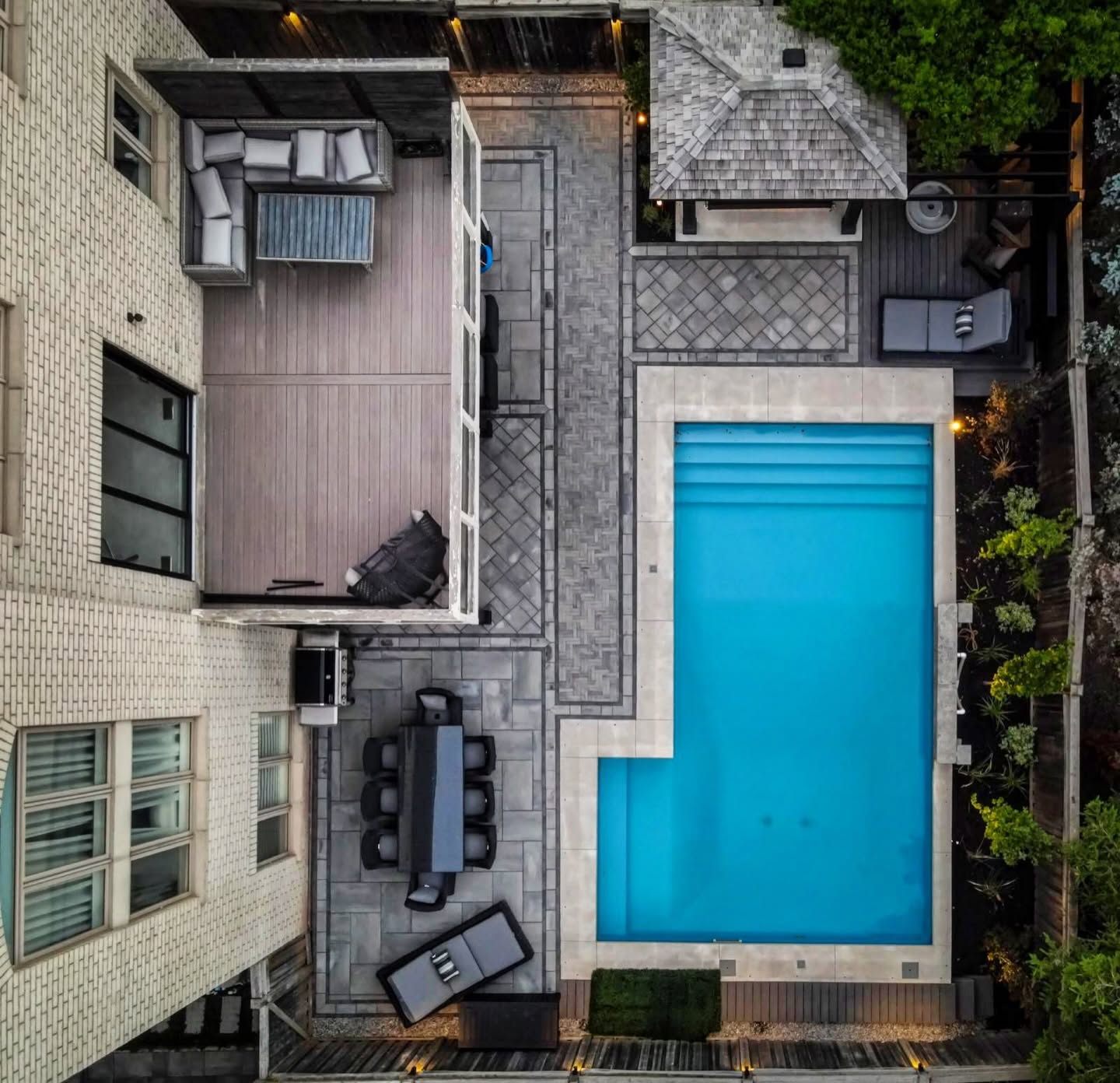 Aerial view of a full backyard build by MADDA-WORX in Oakville with pool, paver patio and covered pergola